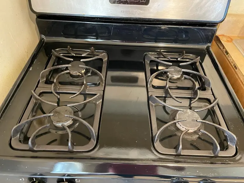 Sparkling clean black stovetop after deep cleaning